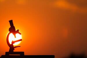 The microscopic silhouette placed on the table and the background is a beautiful view of the setting sun in the evening. photo