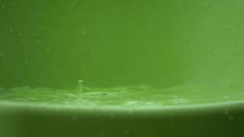 water rain drop and splash with green plastic on the bottom video