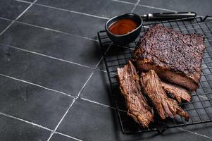 Chopped Beef Brisket barbecue, Traditional meat rubbed with spices and smoked in a Texas smoker. Black background. Top view. Copy space photo