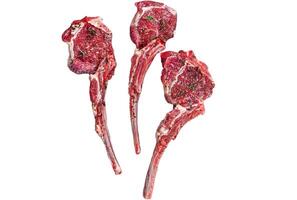 Raw uncooked lamb mutton meat chops steaks on a butcher cleaver. Isolated on white background. photo