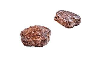 Grilled fillet mignon or tenderloin beef steak on kitchen table. Isolated on white background. photo