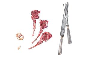 Uncooked lamb meat chops steaks on a butcher table with pepper and thyme. Isolated on white background, top view. photo