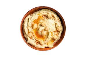 Hummus paste with pita bread, chickpea and parsley in a wooden bowl. Isolated, white background. Top view. photo