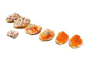 Smoked salmon and red caviar toasts appetizer with cream cheese. Isolated on white background, top view. photo