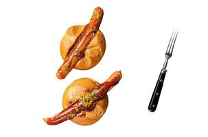 Deutsche Bockwurst sausage in a bun with French fries and curry sauce, currywurst. Isolated, white background. photo