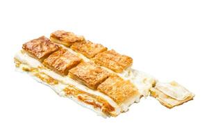 Turkish cheese stuffed filo dough borek or Su boregi. Isolated, white background. photo