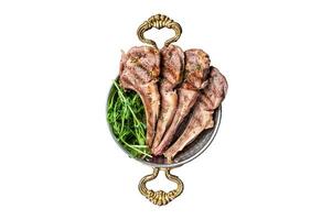 Grilled Lamb mutton Chops steaks in a skillet with green salad. Isolated, white background. photo