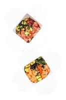 Wok noodle in paper box with vegetables , salmon and tuna. street food to go, take away. Isolated on white background. Top view. photo