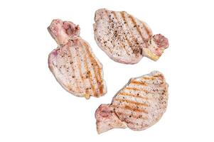 Fried on a grill skillet pork chop steaks. Isolated, white background. photo
