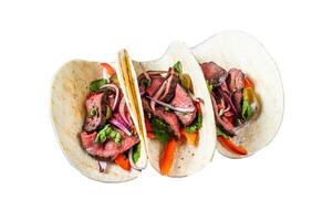 Homemade Mexican Steak Steet Tacos with Cilantro, green sauce, jalapenos and onion. Isolated on white background. photo