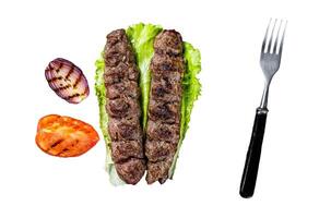 Grilled Urfa kebab with tomato, salad and onion. Isolated, white background. photo