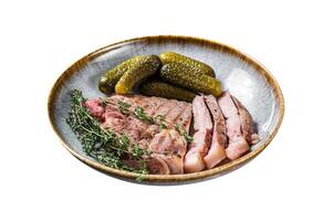 Barbecue dinner - Pork steaks from neck meat in plate with hebs. Isolated on white background. Top view. photo