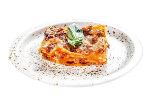 Traditional lasagna made with minced beef, bolognese and bechamel sauces. Isolated on white background. Top view. photo