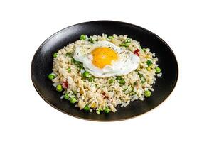 Fried rice with chicken, egg and vegetables in a plate. Isolated on white background. photo