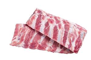 Rack of raw pork spare ribs on butcher table. Isolated on white background. photo