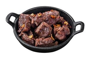 Grilled Sauteed Diced Beef in a skillet with garlic. Isolated on white background. Top view. photo