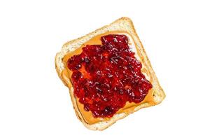 Peanut butter and jelly on white bread toasts. Isolated on white background. Top view. photo