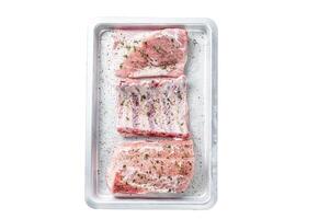 Set of Raw pork cuts, loin meat, spare ribs and brisket. Isolated on white background, top view. photo