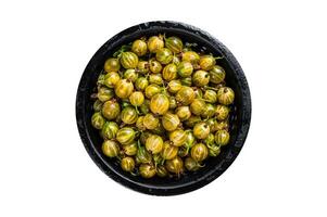 Fresh green gooseberries in a colander. Isolated, white background. Top view. photo