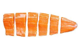 Sliced salmon fillet, raw fish meat with thyme and rosemary Isolated on white background. photo