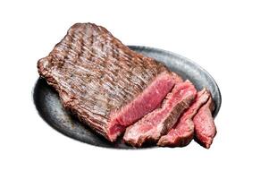 Grilled Flap or Flank Steak, sliced on a plate. Isolated on white background. Top view. photo