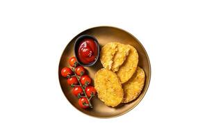 Roast Hash brown potato, Vegetable fritters in a plate with tomato sauce. Isolated on white background. photo