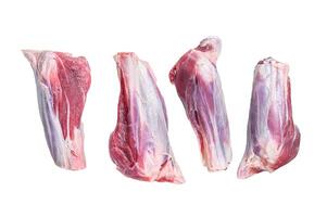 Raw lamb shanks meat on stone table. Isolated on white background. photo
