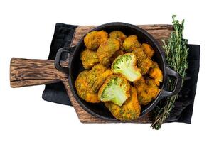 Roasted Crumbed broccoli in a pan. Isolated on white background. photo