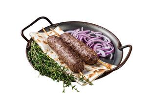 Turkish Adana Kebab from mince lamb beef meat on Skewer with flatbread and onion. Isolated on white background. Top view. photo
