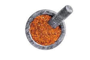 Cooking of Red Chili pepper and paprika flakes isolated on white background. top view photo