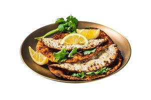 Turkish lahmacun pizza with mince meat and tomatoes on a plate with parsley and lemon. Isolated on white background. Top view. photo