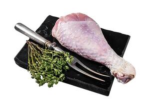 Raw turkey leg thigh with thyme and spices. Isolated on white background. Top view. photo