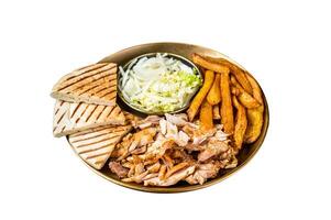Turkish Doner kebab or gyros on a plate with french fries, vegetables and salad. Isolated on white background. photo