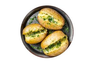Baked Jacket potatoes with cheese, herbs and butter. Isolated on white background. photo
