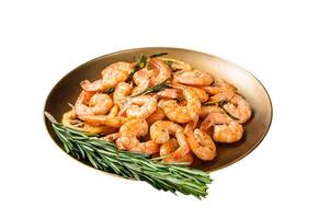 Spicy garlic chilli Prawns Shrimps with lemon and rosemary on a plate. Isolated on white background. Top view. photo