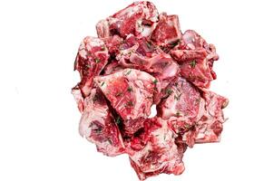 Raw mutton meat diced for goulash or stew with bone Isolated on white background, top view. photo
