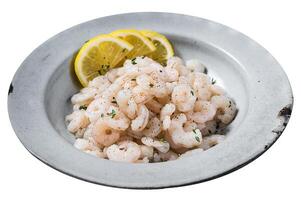 Boiled shrimps seafood with lemon, herbs and spice, prawns peeled. Isolated on white background. Top view. photo