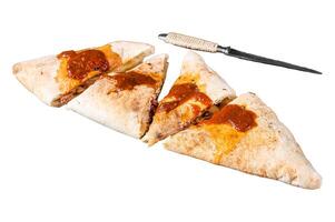 Cut and sliced Calzone closed pizza with ham and cheese Isolated on white background, top view. photo