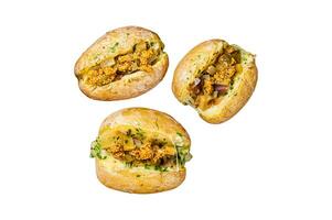 Turkish Kumpir, baked potatoes stuffed with cheese, bacon, salty cucumber, herbs and butter. Isolated, white background. photo