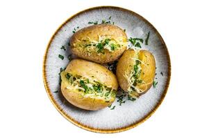Baked Jacket potatoes with cheese and butter. Isolated on white background. photo