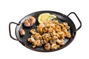 Grilled Shrimps prawns with garlic, olive oil and lemon in a tray. Isolated on white background. Top view. photo