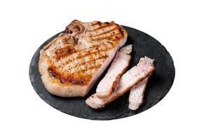 Roast BBQ pork Chop or T-bone meat steak sliced on a board. Isolated on white background. photo