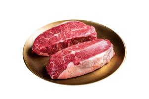 Raw Shoulder Top Blade beef meat steaks on a plate. Isolated on white background. Top view. photo