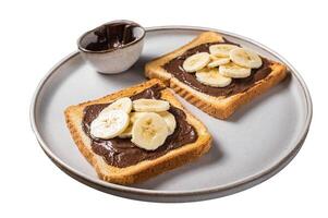 Cooking of sandwich with chocolate Hazelnut butter and bananas. Isolated on white background. Top view. photo
