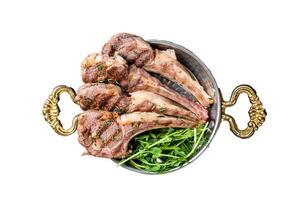 Grilled Lamb mutton Chops steaks in a skillet with green salad. Isolated, white background. photo
