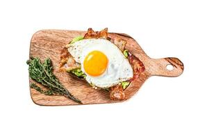 Toast with avocado, fried bacon and egg. Isolated on white background. Top view. photo