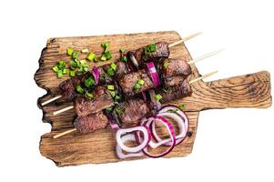 Shashlik grilled meat skewers, shish kebab with beef and lamb meat, onion and herbs. Isolated on white background. photo