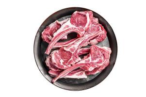 Raw lamb mutton chop steaks, fresh meat cutlets on butcher table. Isolated on white background. photo