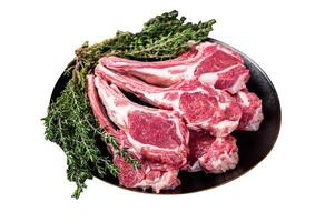 Raw lamb chops, fresh mutton meat cutlets on a ribs. Isolated on white background. Top view. photo