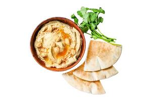 Hummus paste with pita bread, chickpea and parsley in a wooden bowl. Isolated on white background, top view. photo